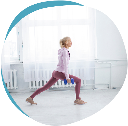 Woman performing a lunge exercise with dumbbells to strengthen the knee