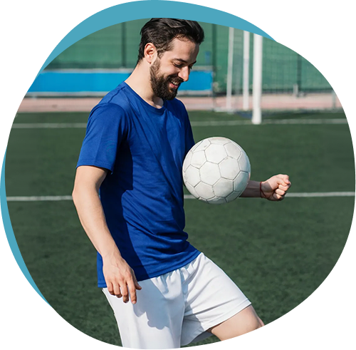 Active man playing football, representing improved mobility from joint care treatment